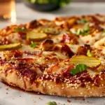 Big Mac pizza with sesame crust and toppings on marble counter