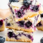 blueberry coconut bars on marble surface