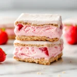 Stacked strawberry ice cream sandwich bars with visible chunks of fruit