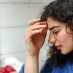 Woman experiencing zepbound hair loss gently touching thinning hair