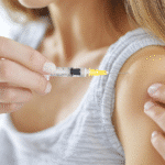 Close-up of a woman self-administering a GLP-1 injection in her upper arm, representing Zepbound usage.