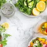 Colorful spread of healthy recipes for weight loss including smoothies, teas, and protein-rich meals on a rustic wooden table