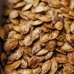 Bowl of roasted spicy pumpkin seeds seasoned for a tasty snack