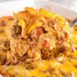 Delicious creamy hamburger casserole with green beans topped with cheese.