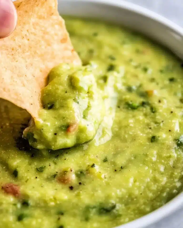 Bowl of guacamole salsa with fresh ingredients, perfect for dipping or topping