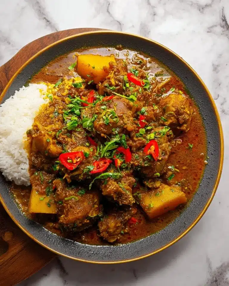 Delicious Jamaican Curry Chicken served with rice and vegetables