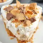 Peanut Butter Butterfinger Cream Cheese Pie decorated with chocolate and butterfinger bits
