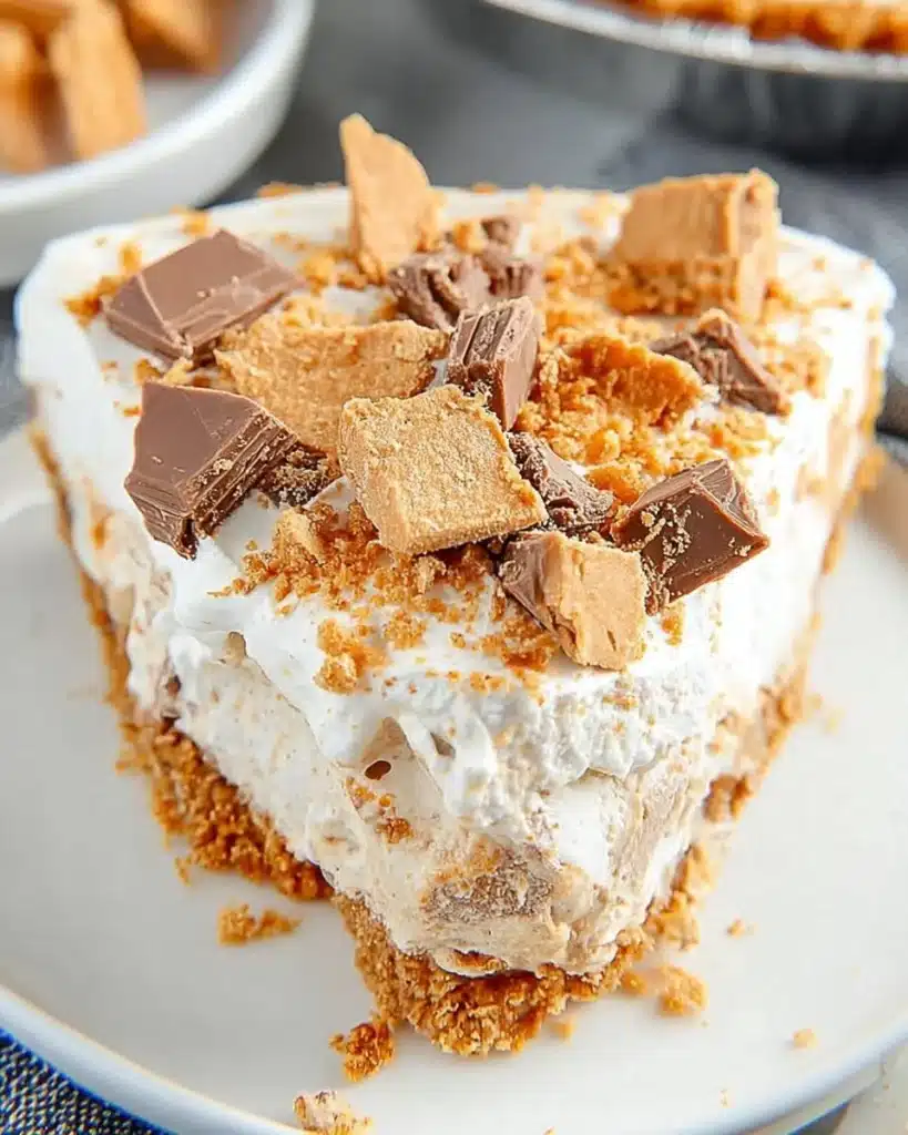 Peanut Butter Butterfinger Cream Cheese Pie decorated with chocolate and butterfinger bits