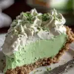 Delicious Shamrock Shake Pie topped with green whipped cream and lucky sprinkles.