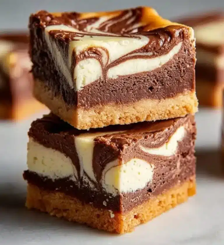 Delicious Nutella swirl cheesecake bars on a white plate