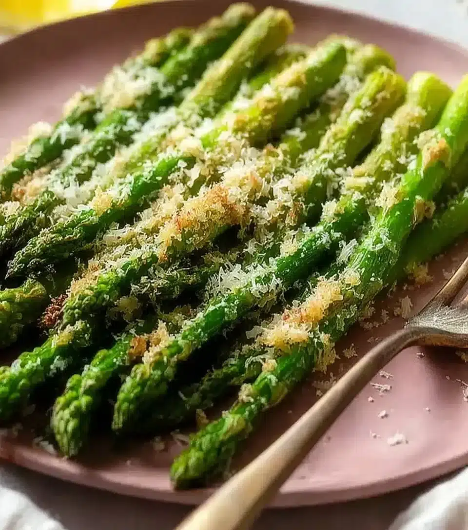 Delicious Parmesan Roasted Asparagus garnished with cheese and herbs.