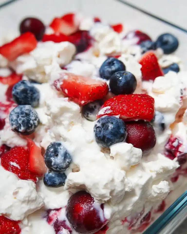 Red, White, and Blue Cheesecake Salad with fresh berries and creamy topping