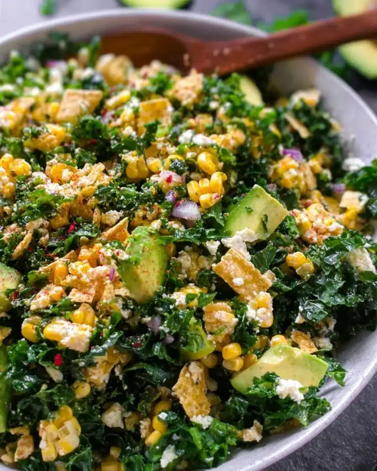 Colorful Street Corn Kale Salad topped with fresh ingredients and spices.