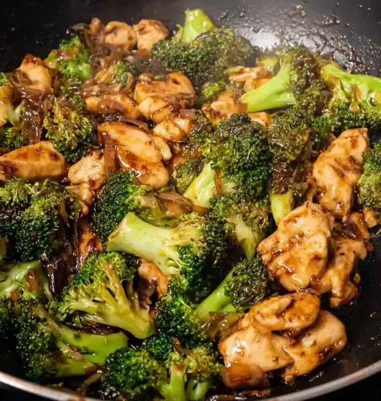 Delicious plate of chicken and broccoli dish on a wooden table