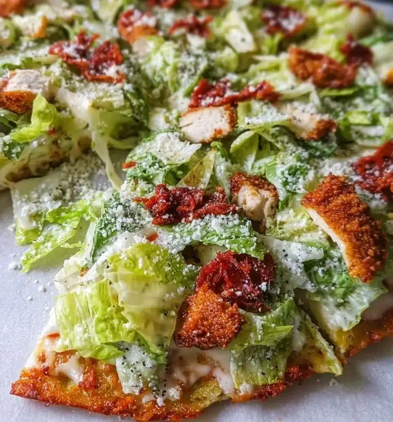 Delicious Chicken Caesar Salad Pizza topped with lettuce, grilled chicken, and Caesar dressing