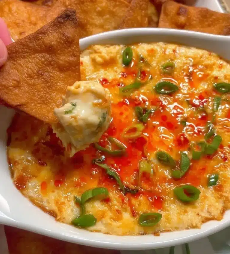 Delicious Crab Rangoon Dip served in a bowl with crispy crackers