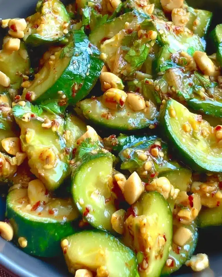 Peanut cucumber salad garnished with fresh herbs and peanuts