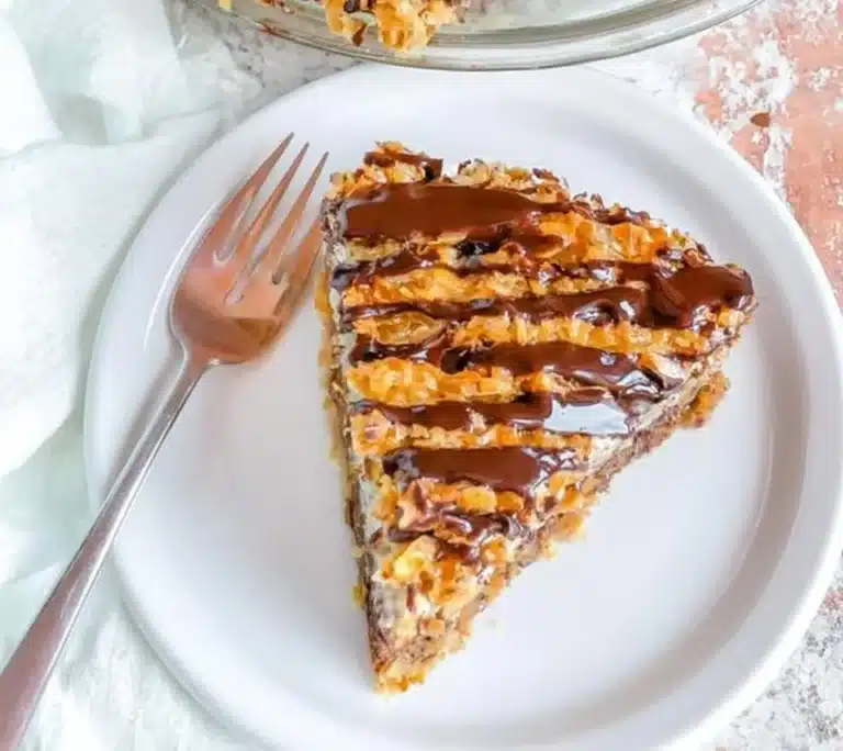 Delicious Samoa Pie with chocolate, coconut, and caramel drizzled topping.