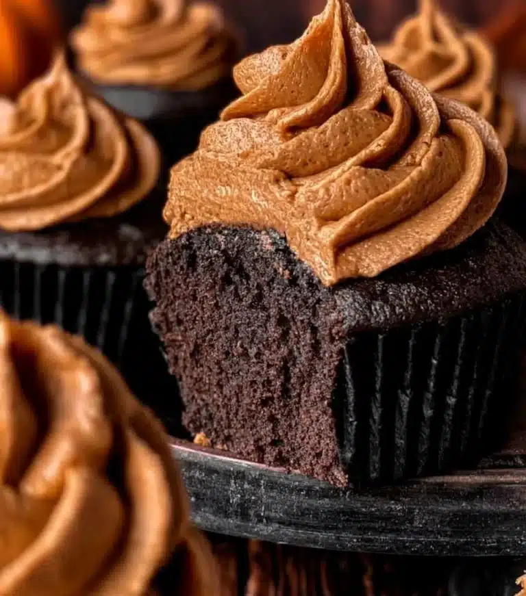 Delicious Chocolate Pumpkin Cupcakes topped with creamy frosting