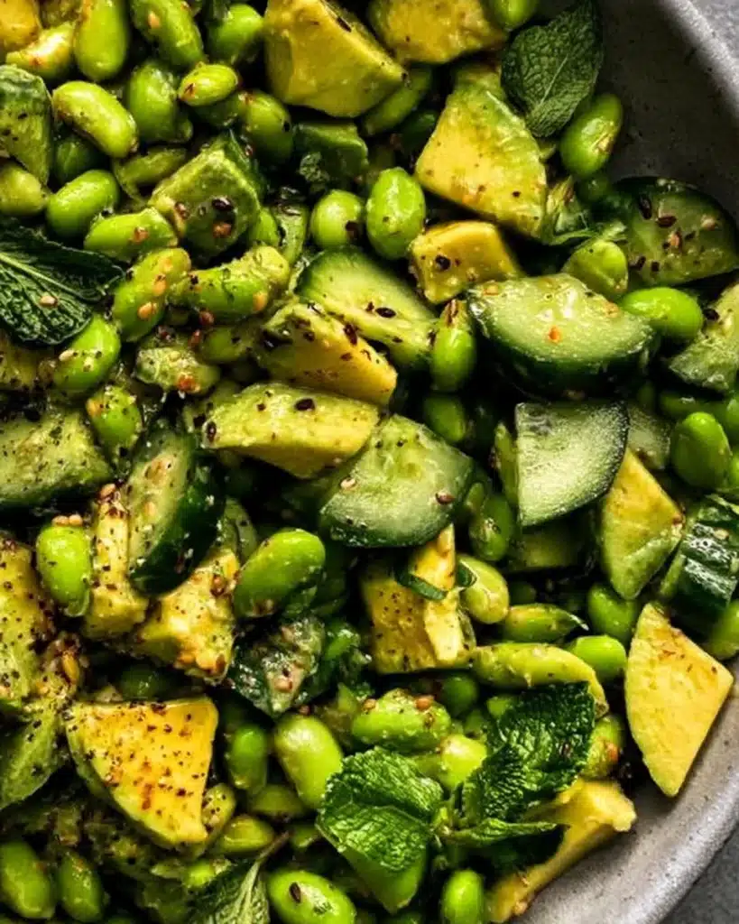 Cucumber salad with edamame and avocado in a bowl, fresh and healthy dish.