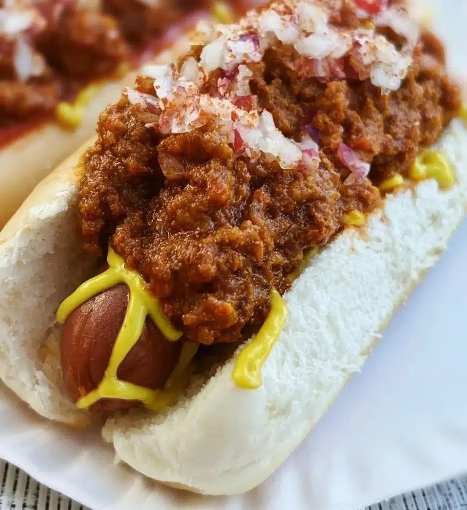 Delicious hot dog chili served over grilled hot dogs with toppings.