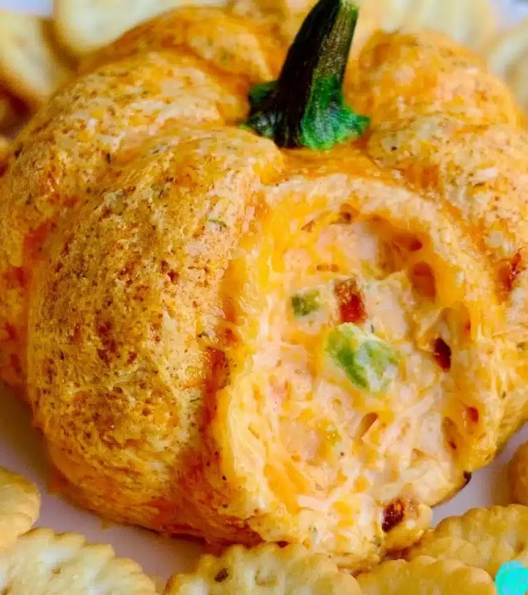 Pumpkin-shaped cheeseball decorated for a festive autumn party.