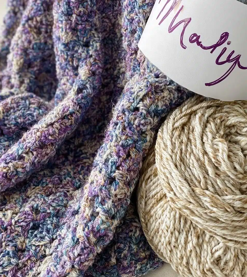 Handcrafted crocheted shawl showcasing intricate patterns and vibrant colors.